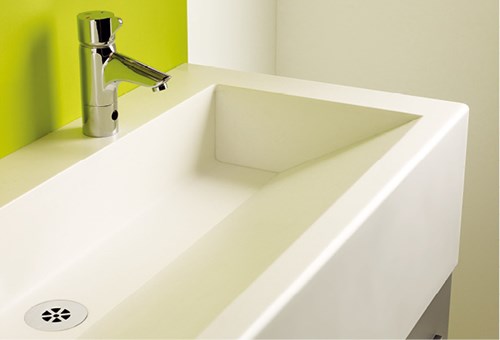 Solid Surface washtroughs and vanity units with seamless, DfE-compliant design in a modern school washroom.