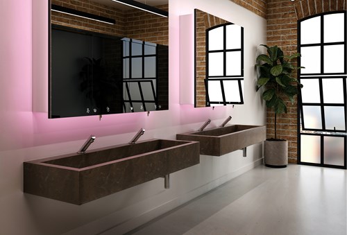 Wall-mounted solid surface washtroughs in a modern commercial washroom